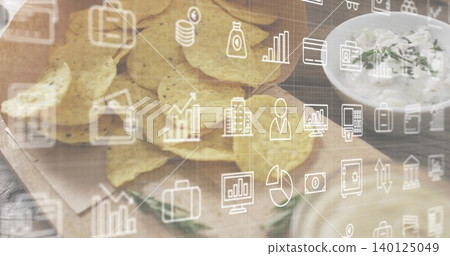 Showing yellow tortilla chips on kitchen-counter with white bowl herb dip and data-icons overlay Showing yellow tortilla chips on kitchen-counter with white bowl herb dip and data-icons overlay 140125049