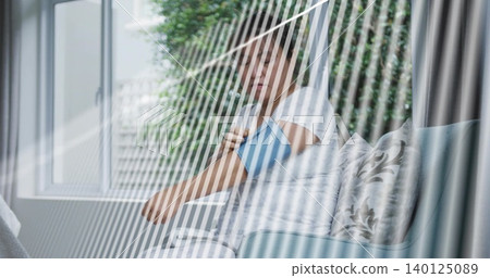 Checking mature man wearing white T-shirt taking blood pressure at living room sofa with blue cuff Checking mature man wearing white T-shirt taking blood pressure at living room sofa with blue cuff 140125089