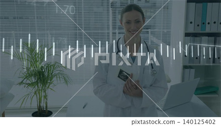 Holding mid adult female clinician wearing lab coat showing sonogram in clinic, with stethoscope Holding mid adult female clinician wearing lab coat showing sonogram in clinic, with stethoscope 140125402