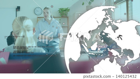 Teaching woman in blue shirt and jeans speaking at front of class, with whiteboard, globe overlay Teaching woman in blue shirt and jeans speaking at front of class, with whiteboard, globe overlay 140125432