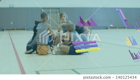 Sitting seven kids in gray shirts, listening, one speaking in gym with basketball, ladder, overlays Sitting seven kids in gray shirts, listening, one speaking in gym with basketball, ladder, overlays 140125434