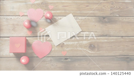 Displaying Valentine cluster on rustic wood table, with blank white card, pink hearts and gift box Displaying Valentine cluster on rustic wood table, with blank white card, pink hearts and gift box 140125440