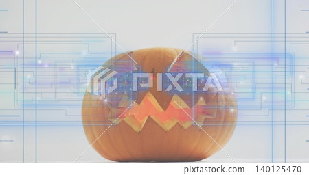 Glowing jack-o-lantern on tabletop, displaying triangular eyes zigzag mouth and blue HUD overlays Glowing jack-o-lantern on tabletop, displaying triangular eyes zigzag mouth and blue HUD overlays 140125470