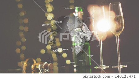 Glowing two champagne flutes catching bright glare on shiny table, showing green bottle, globe Glowing two champagne flutes catching bright glare on shiny table, showing green bottle, globe 140125471