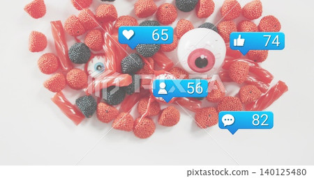 Displaying red and black gummy pile with licorice and plastic eyes on white backdrop, blue bubbles Displaying red and black gummy pile with licorice and plastic eyes on white backdrop, blue bubbles 140125480