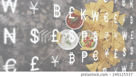 Displaying triangular tortilla chips and three bowls on dark tabletop, currency overlay, copy space Displaying triangular tortilla chips and three bowls on dark tabletop, currency overlay, copy space 140125537
