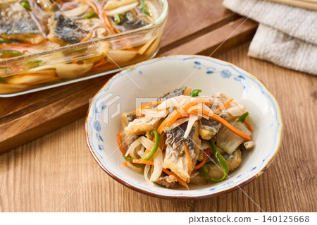 Marinated horse mackerel (Nanban-style), a pre-made dish taken from a storage container. Marinated horse mackerel (Nanban-style), a pre-made dish taken from a storage container. 140125668