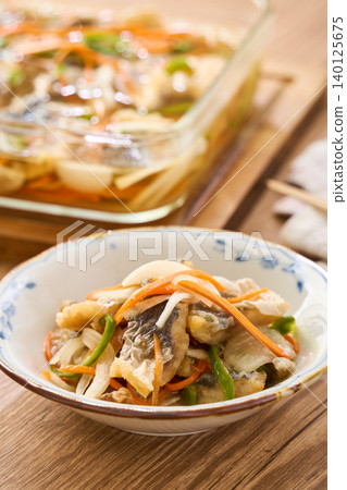 Marinated horse mackerel (Nanban-style), a pre-made dish taken from a storage container. Marinated horse mackerel (Nanban-style), a pre-made dish taken from a storage container. 140125675