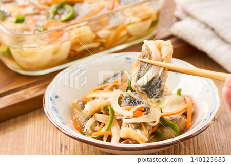 Marinated horse mackerel (Nanban-style), a pre-made dish taken from a storage container. Marinated horse mackerel (Nanban-style), a pre-made dish taken from a storage container. 140125683