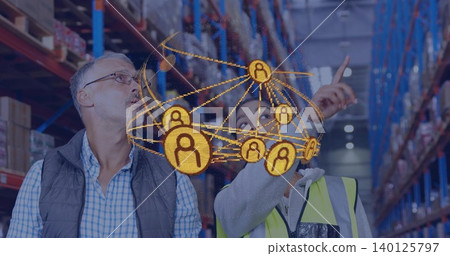 Pointing woman in hi vis vest guiding male manager in quilted vest in warehouse, hologram network Pointing woman in hi vis vest guiding male manager in quilted vest in warehouse, hologram network 140125797