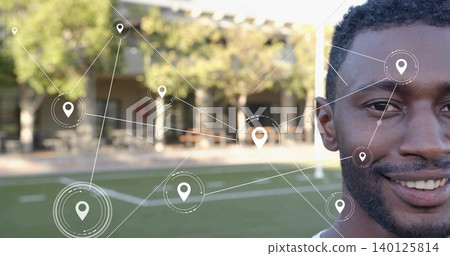 Smiling man in white tee looking at camera on turf with columns, map-pin overlays, copy space Smiling man in white tee looking at camera on turf with columns, map-pin overlays, copy space 140125814