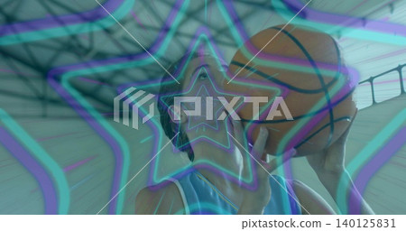 Holding woman aiming basketball at gym, sleeveless jersey, neon overlay, roof trusses and skylights 140125831