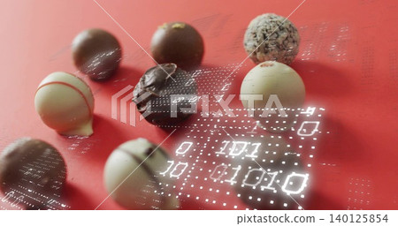 Displaying assorted chocolate truffles and bonbons on red matte tabletop, showing binary grid Displaying assorted chocolate truffles and bonbons on red matte tabletop, showing binary grid 140125854