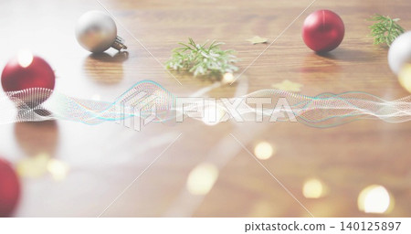 Showing dotted waveform running across wood table with red or silver baubles pine gold stars lights Showing dotted waveform running across wood table with red or silver baubles pine gold stars lights 140125897