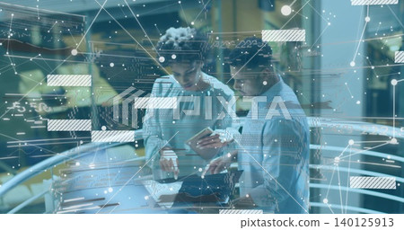 Leaning pair in shirt and blouse checking laptop at atrium glass rail, phone and network graphics 140125913