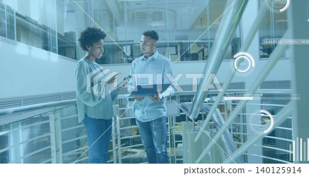 Pointing woman, listening man in business wear discussing tablet on mezzanine, holding laptop, HUD Pointing woman, listening man in business wear discussing tablet on mezzanine, holding laptop, HUD 140125914