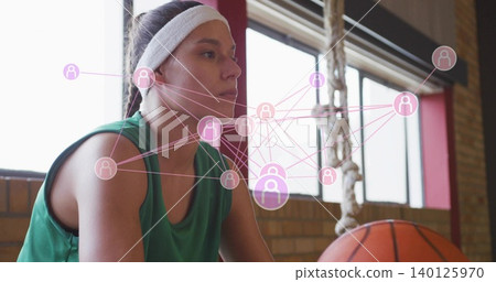 Sitting athlete in green jersey white headband studying court in gym with basketball rope pink data Sitting athlete in green jersey white headband studying court in gym with basketball rope pink data 140125970