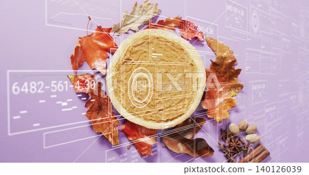 Showcasing round tart in tart pan on purple surface, with leaves, cinnamon, nuts, HUD Showcasing round tart in tart pan on purple surface, with leaves, cinnamon, nuts, HUD 140126039