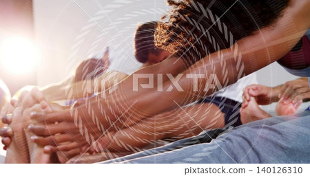 Stretching foursome reaching forward in yoga studio, with mats, athletic clothes, spiral overlay Stretching foursome reaching forward in yoga studio, with mats, athletic clothes, spiral overlay 140126310