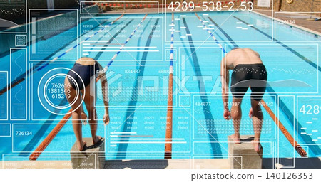 Leaning forward swimmers gripping starting blocks at pool in onepiece and jammers, orange ropes HUD Leaning forward swimmers gripping starting blocks at pool in onepiece and jammers, orange ropes HUD 140126353