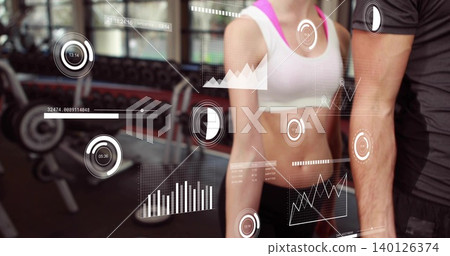 Standing fit female white-sports-bra pink-straps and male dark-tshirt, showing HUD at gym dumbbells 140126374