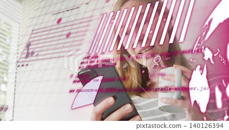 Smiling woman wearing striped top holding smartphone and white mug in home office, pink overlay Smiling woman wearing striped top holding smartphone and white mug in home office, pink overlay 140126394