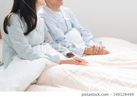 A couple waking up and having a conversation in bed A couple waking up and having a conversation in bed 140126499
