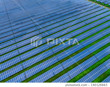 Aerial view of solar farm. Sustainable renewable energy and modern photovoltaic technology for eco-friendly electricity production. Solar power station. Green energy solutions. Solar panel technology. Aerial view of solar farm. Sustainable renewable energy and modern photovoltaic technology for eco-friendly electricity production. Solar power station. Green energy solutions. Solar panel technology. 140126663