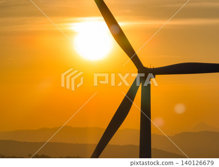 Wind farm field and sunset sky. Wind power. Sustainable, renewable energy. Wind turbines generate electricity. Sustainable development. Green technology for energy sustainability. Eco-friendly energy. Wind farm field and sunset sky. Wind power. Sustainable, renewable energy. Wind turbines generate electricity. Sustainable development. Green technology for energy sustainability. Eco-friendly energy. 140126679
