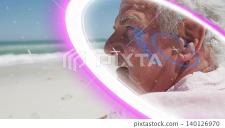 Gazing senior man in pastel shawl facing shoreline, neon ring and blue doodles overlay, copy space Gazing senior man in pastel shawl facing shoreline, neon ring and blue doodles overlay, copy space 140126970