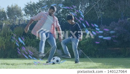 Playing dad and son kicking soccer ball in backyard, wearing pink-plaid shirt purple-blue streaks Playing dad and son kicking soccer ball in backyard, wearing pink-plaid shirt purple-blue streaks 140127064
