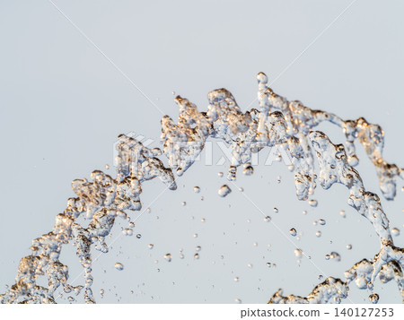 Splashes and jets of water against light background. Splashes and jets of water against light background. 140127253