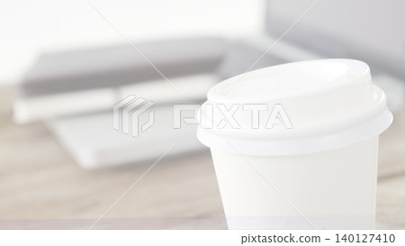 showing flat design white coffee cup on simple desk with closed laptop in business workspace showing flat design white coffee cup on simple desk with closed laptop in business workspace 140127410