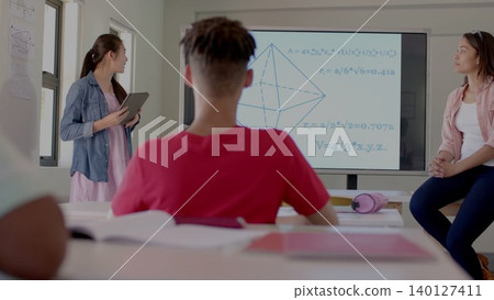 Students are solving geometry problems on tablet with 3D pyramid screen in flat design classroom Students are solving geometry problems on tablet with 3D pyramid screen in flat design classroom 140127411
