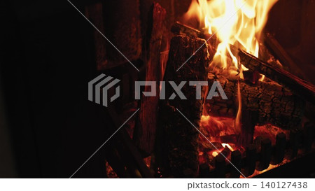 Flat design illustration is showing burning logs on metal grate with glowing flames for home design Flat design illustration is showing burning logs on metal grate with glowing flames for home design 140127438