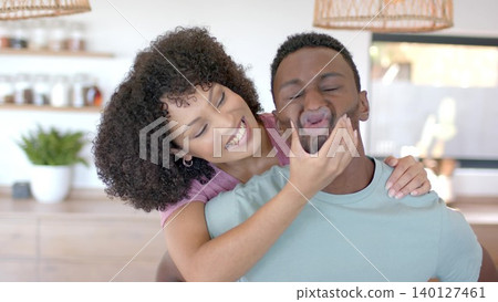 Couple is playfully interacting in flat kitchen for home with pendant lights shelves, copy space Couple is playfully interacting in flat kitchen for home with pendant lights shelves, copy space 140127461