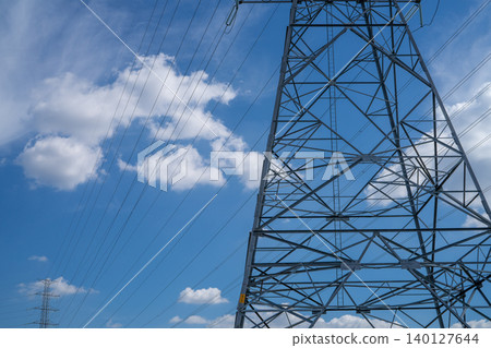 High voltage electric transmission tower with power lines against the sky, highlighting electricity supply, industrial infrastructure, energy distribution, and the challenges of the energy crisis. High voltage electric transmission tower with power lines against the sky, highlighting electricity supply, industrial infrastructure, energy distribution, and the challenges of the energy crisis. 140127644