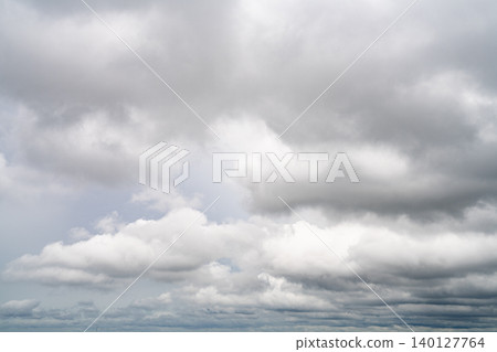 Dramatic overcast sky with gray and white clouds before rainy season storm, moody and gloomy weather background. Climate, meteorology, and atmospheric. Weather forecasting, climate change background. Dramatic overcast sky with gray and white clouds before rainy season storm, moody and gloomy weather background. Climate, meteorology, and atmospheric. Weather forecasting, climate change background. 140127764