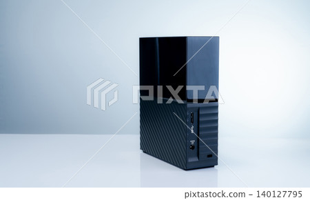 Black solid state external hard drive on white background, perfect for digital data storage and fast backup solutions in modern offices, tech workspaces, and remote setups. Portable SSD device. Black solid state external hard drive on white background, perfect for digital data storage and fast backup solutions in modern offices, tech workspaces, and remote setups. Portable SSD device. 140127795