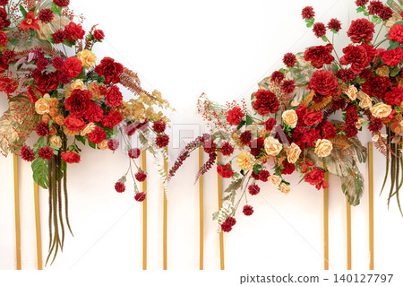 Red flower bouquet with yellow accents arranged as graduation celebration gift for students achieving academic success at university commencement ceremony milestone. Celebration party decorations. Red flower bouquet with yellow accents arranged as graduation celebration gift for students achieving academic success at university commencement ceremony milestone. Celebration party decorations. 140127797