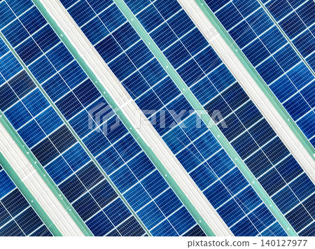 Solar panels on industrial factory rooftop. Renewable energy. Sustainable manufacturing. Green technology. Rooftop solar power. Commercial buildings with efficient renewable energy infrastructure. Solar panels on industrial factory rooftop. Renewable energy. Sustainable manufacturing. Green technology. Rooftop solar power. Commercial buildings with efficient renewable energy infrastructure. 140127977