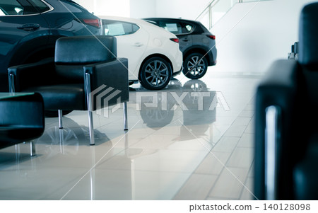 Car parked in luxury showroom. Car dealership office. Car showroom business. New car parked in modern showroom. Auto for sale and rent business. Automobile leasing and insurance. Electric automobile. 140128098