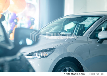Elegant electric vehicle displayed in contemporary car dealership office, highlighting premium auto leasing, insurance options, and the future of urban transportation inside a modern indoor showroom. Elegant electric vehicle displayed in contemporary car dealership office, highlighting premium auto leasing, insurance options, and the future of urban transportation inside a modern indoor showroom. 140128106