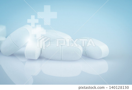 Pile of white antibiotic tablets on smooth gradient background. Pharmaceutical industry. Medical and healthcare. Medication treatment options and drug resistance concerns. White pharmaceutical pills. Pile of white antibiotic tablets on smooth gradient background. Pharmaceutical industry. Medical and healthcare. Medication treatment options and drug resistance concerns. White pharmaceutical pills. 140128130
