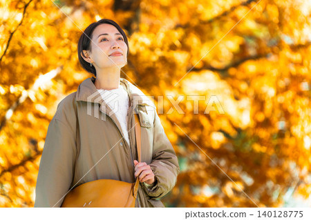 Woman enjoying autumn leaves lifestyle image Woman enjoying autumn leaves lifestyle image 140128775