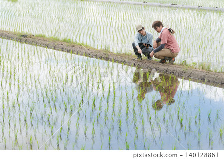 Men using tablets for farming 140128861