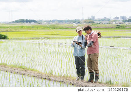 Men using tablets for farming 140129176