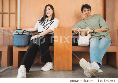 asian couple smile and happy during play with they cat in coffee shop asian couple smile and happy during play with they cat in coffee shop 140129263