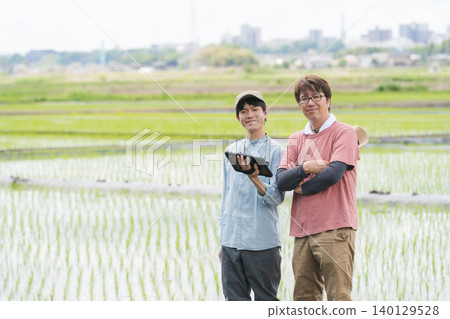 Men using tablets for farming 140129528