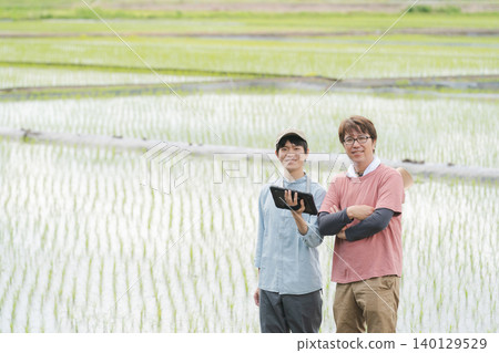 Men using tablets for farming 140129529